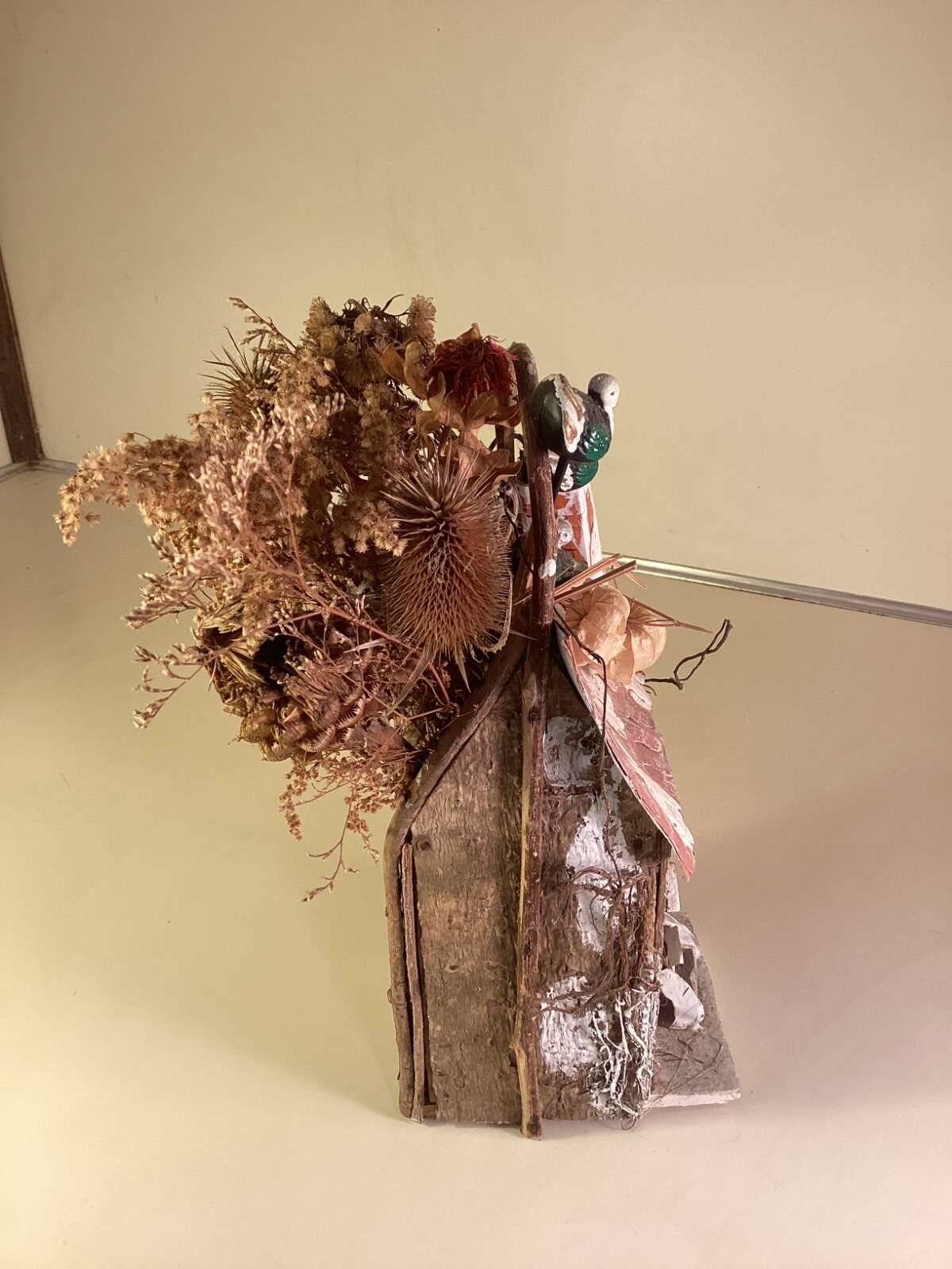 Wood birdhouse centerpiece with dried flowers, turkeys, twigs, windows, chimney