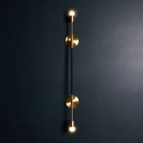 The Double Linear Sconce is solid brass and features an optional leather wrap, h