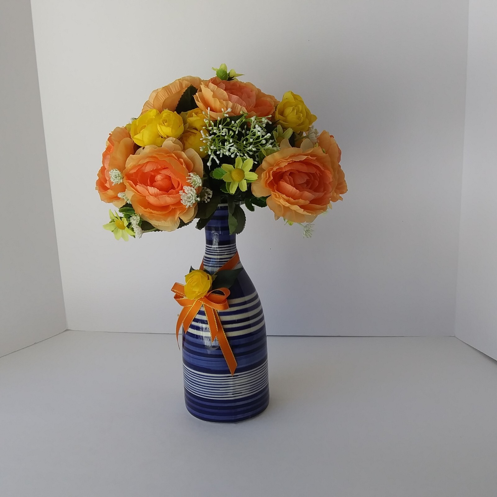 Blue White Striped Pottery Vase with Peach and Yellow Rose Floral Arrangement