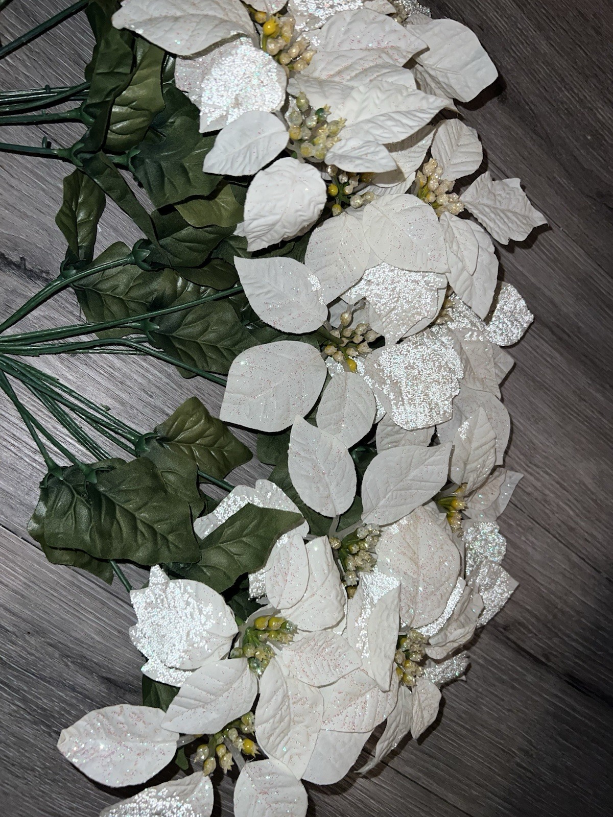 2 artificial white poinsettia bushes with green leaves and sparkle details
