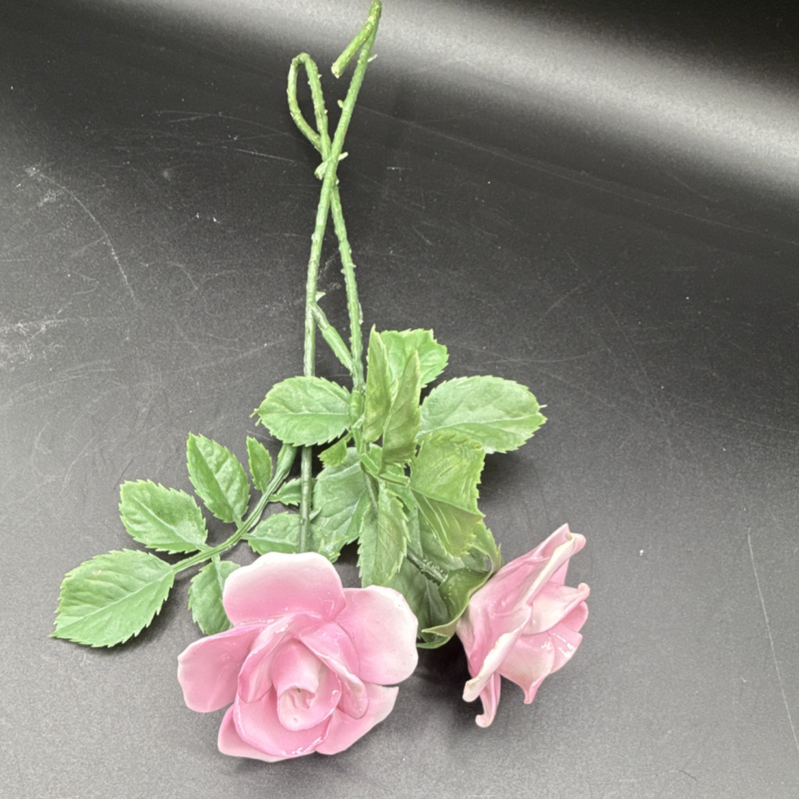 Porcelain flowers, pink roses with plastic stems and leaves