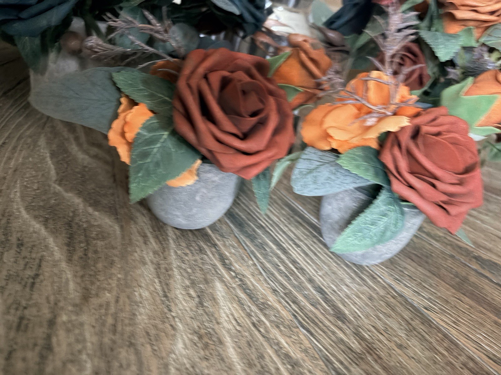 Teal & burnt orange centerpieces, bridal bouquet, and boutonnière. Lings flowers