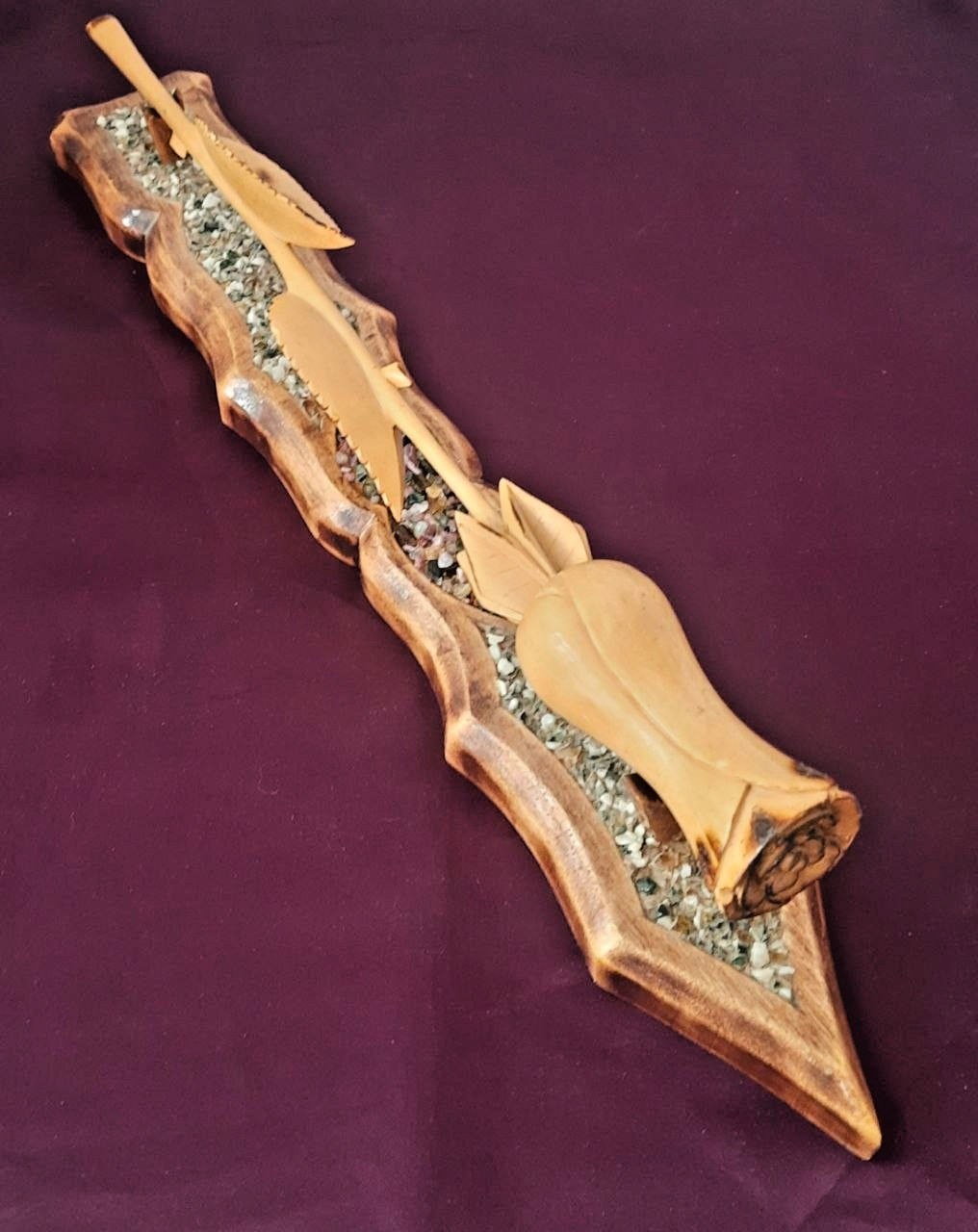 natural wood rose on a stand with hand-carved stones.