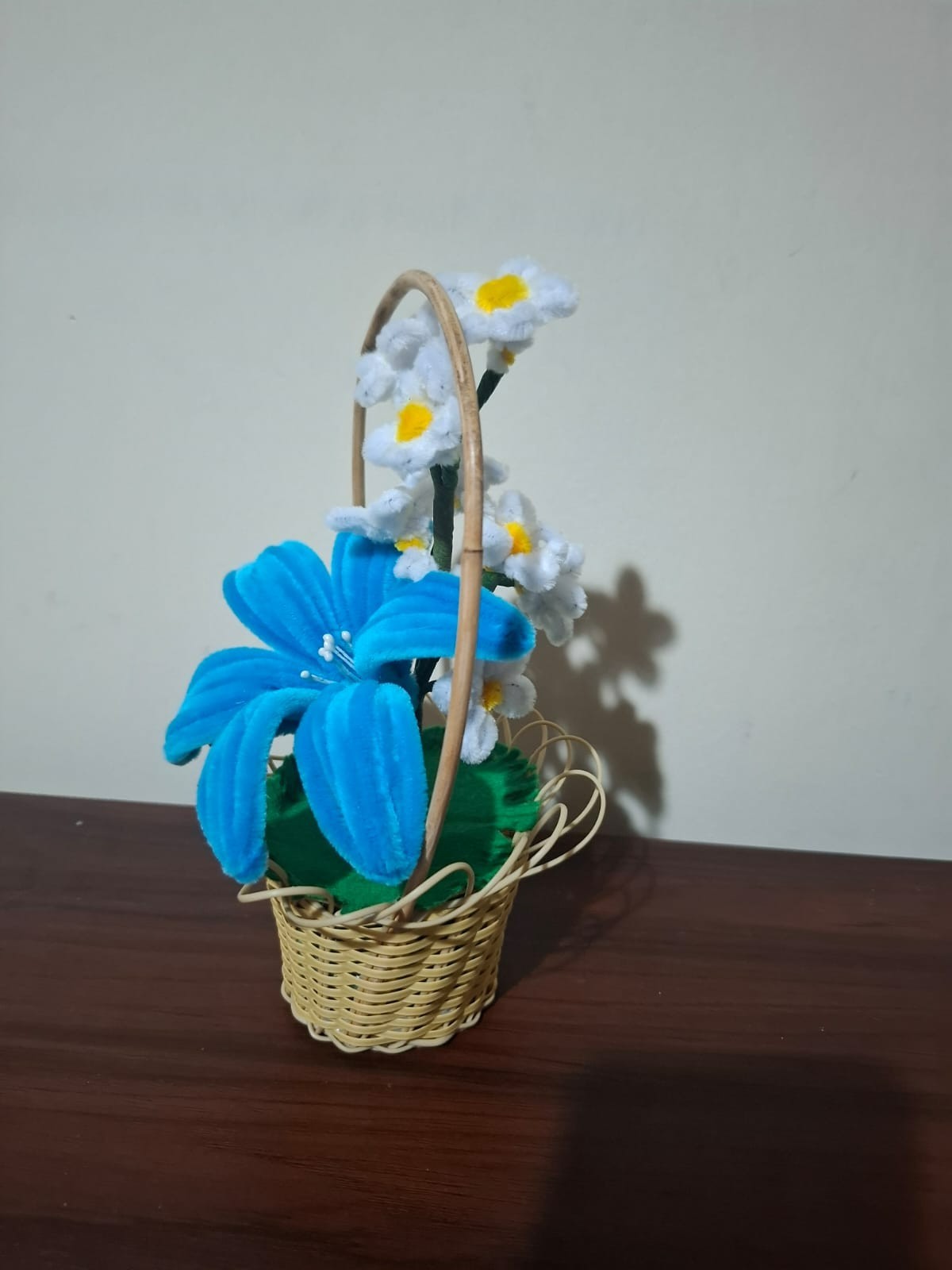 pipe cleaner blue lily flower in a cane basket
