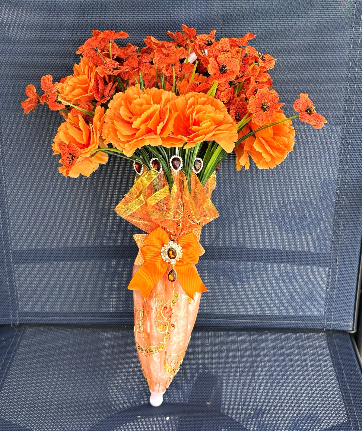 Artificial Orange & Green Carnation Floral Wall Arrangement, Plastic, with Bow