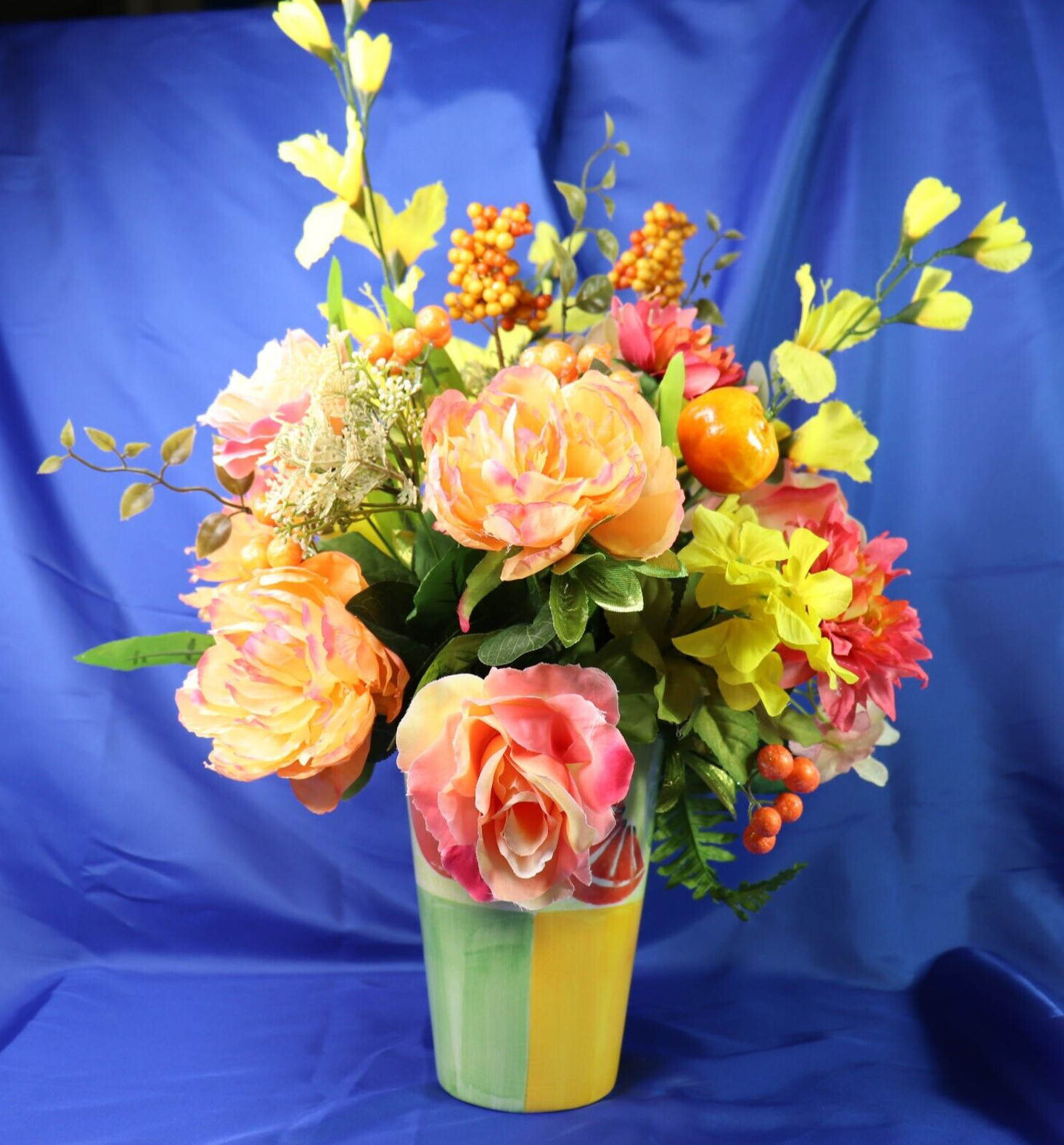 Very Colorful Floral Arrangement In A Beautiful Pitcher With Limes & Oranges