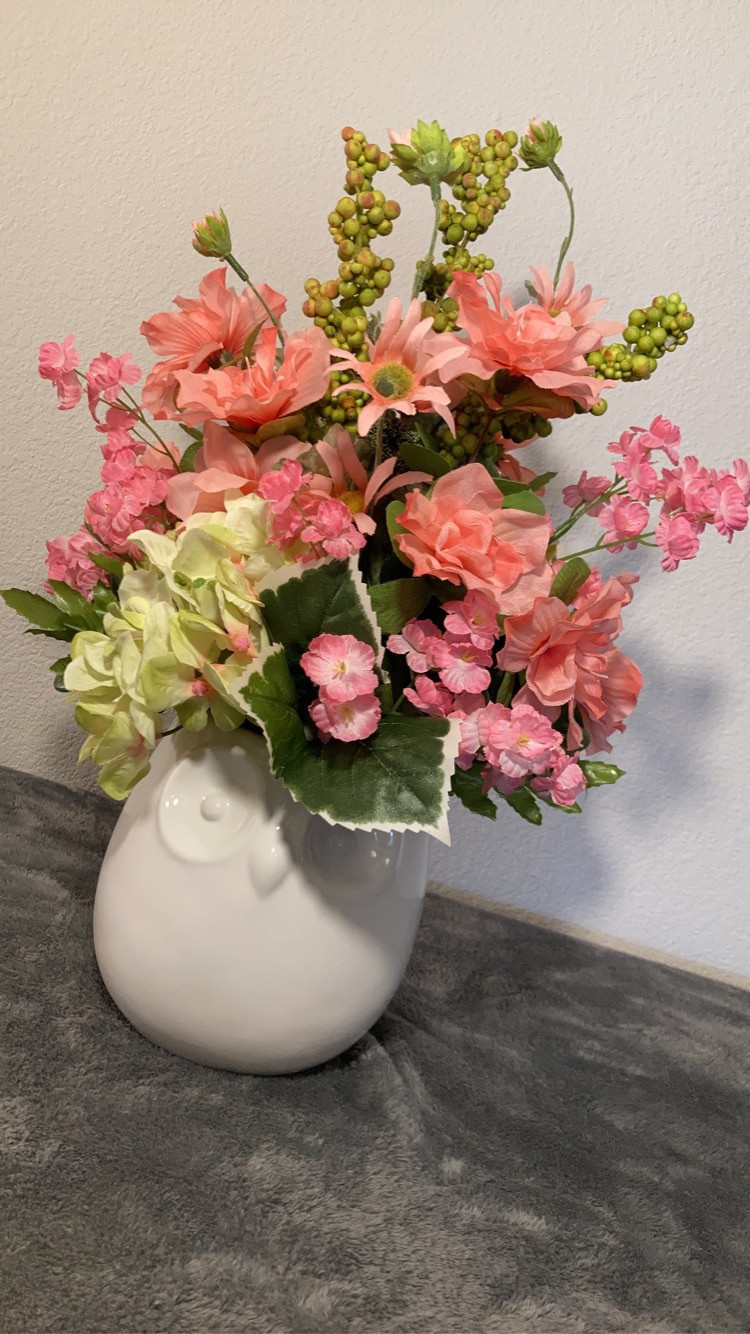Artificial floral arrangement in ceramic owl vase