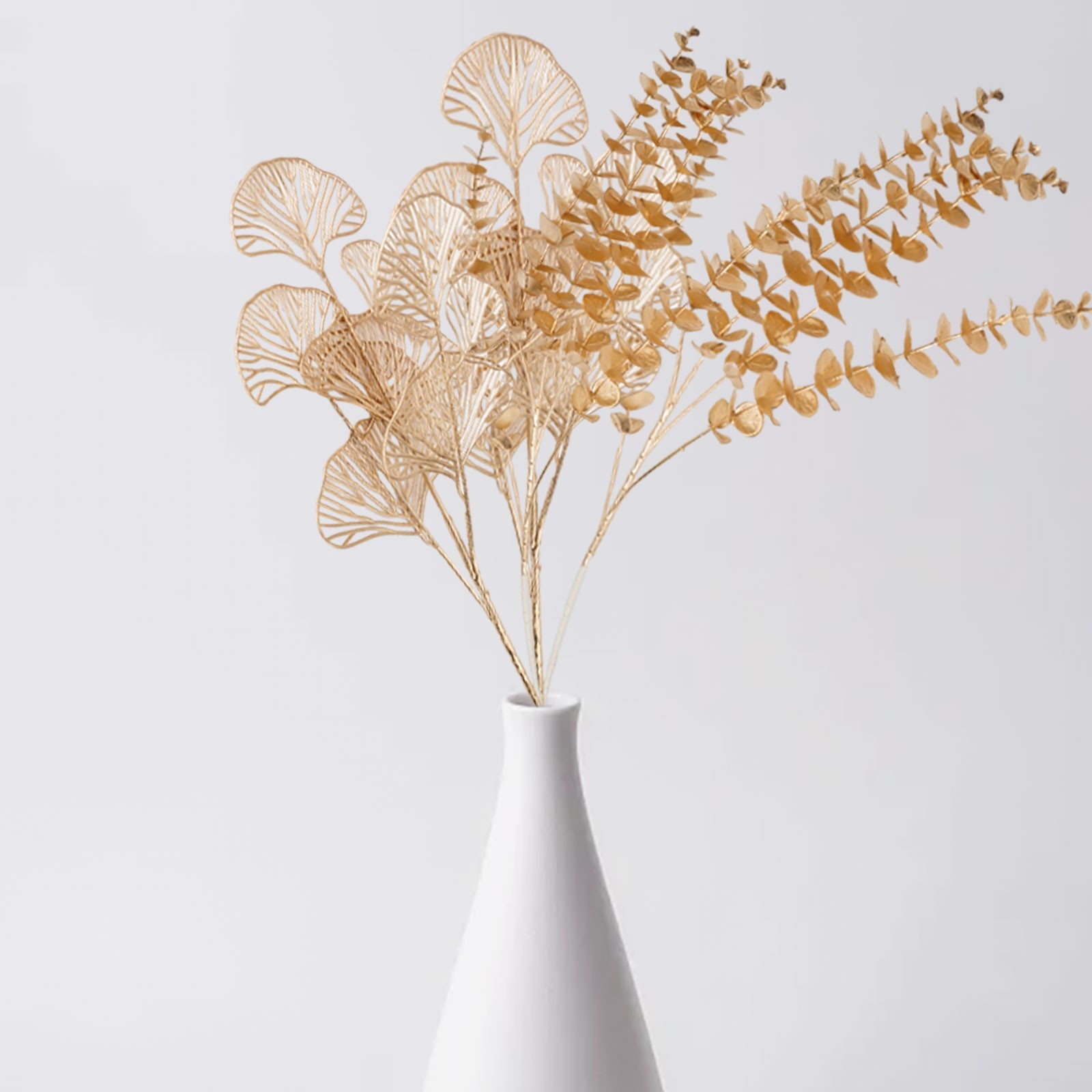 Simulated golden eucalyptus and ginkgo leaf flower arrangement for a chic touch