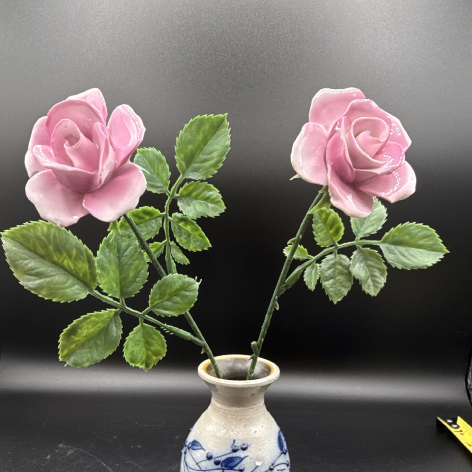 Porcelain flowers, pink roses with plastic stems and leaves