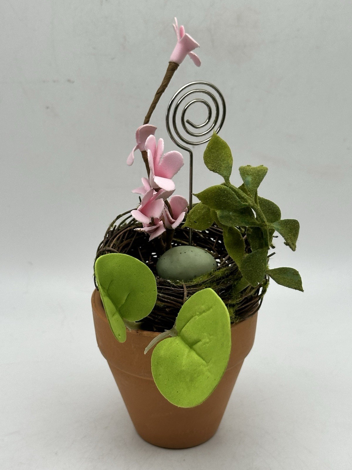 Photo Holder In Spring Themed Pot With Birds Nest Egg Flowers And Foliage