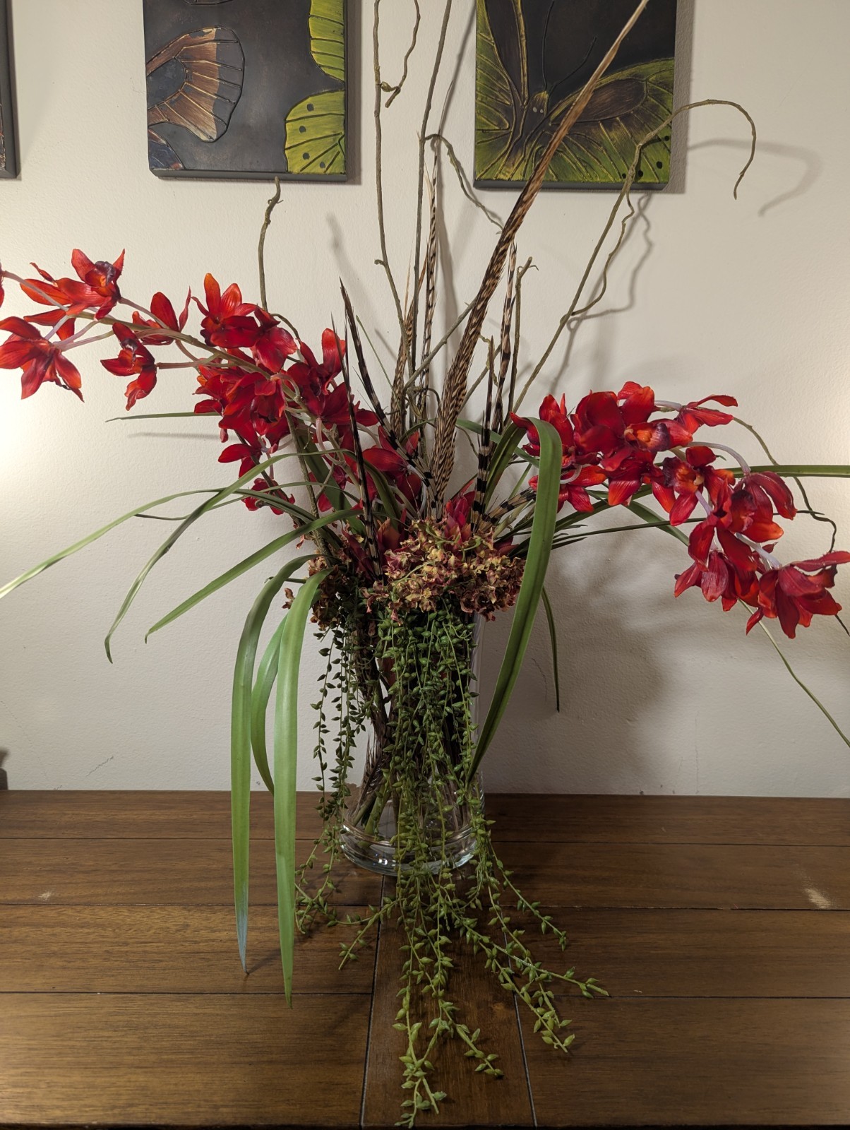 Faux Floral Arrangement With Clear Circular Vase Red Orchards Trailing Greenery