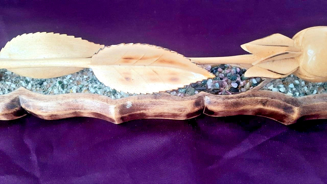 natural wood rose on a stand with hand-carved stones.