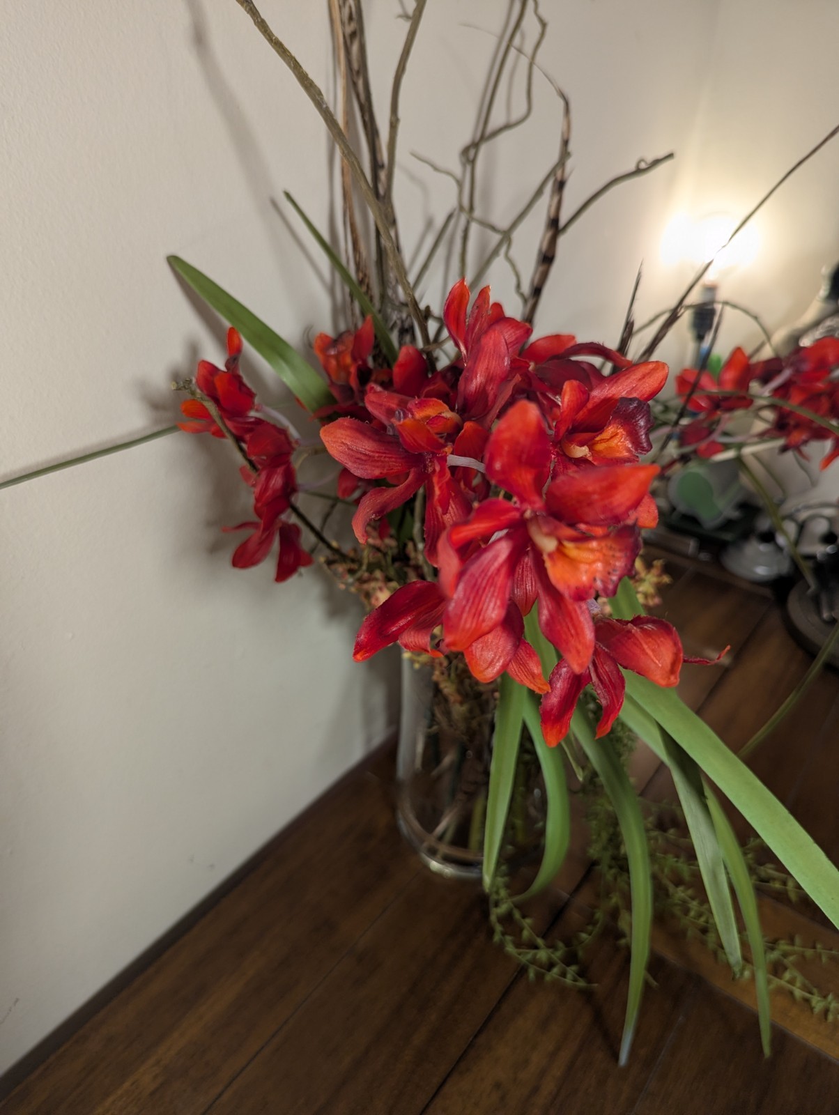 Faux Floral Arrangement With Clear Circular Vase Red Orchards Trailing Greenery