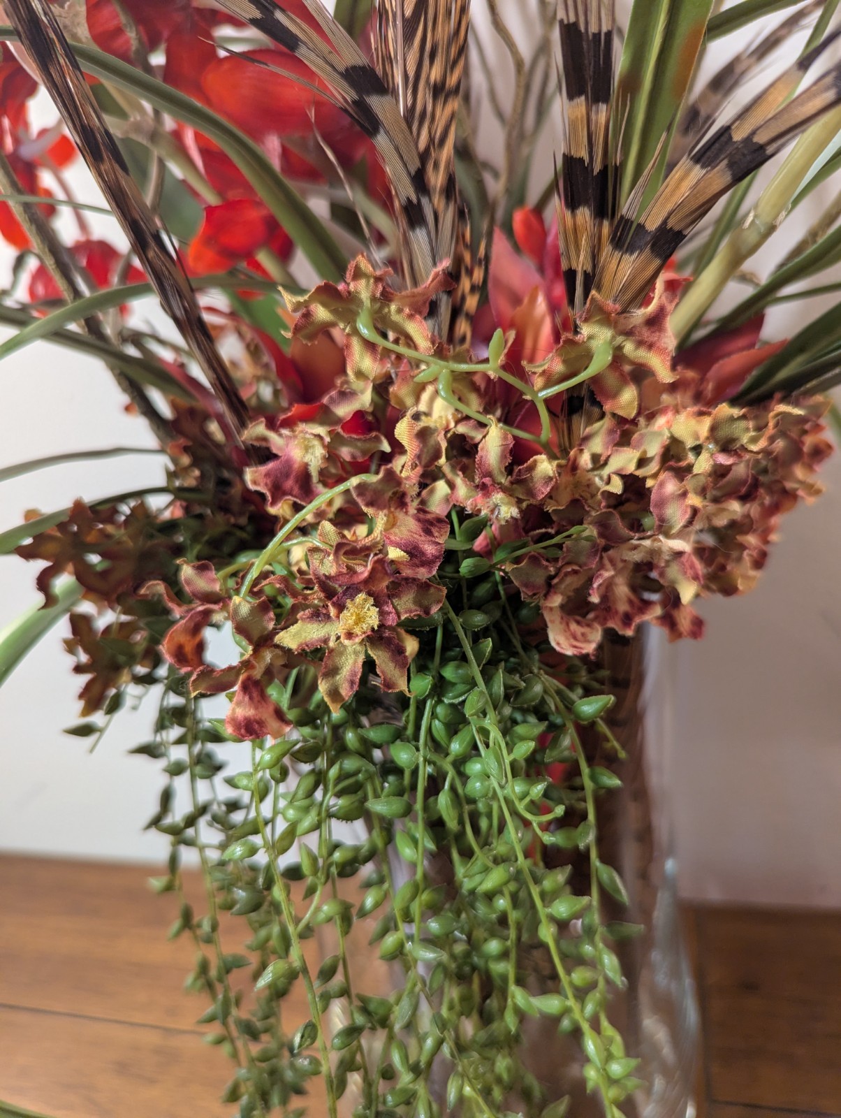 Faux Floral Arrangement With Clear Circular Vase Red Orchards Trailing Greenery