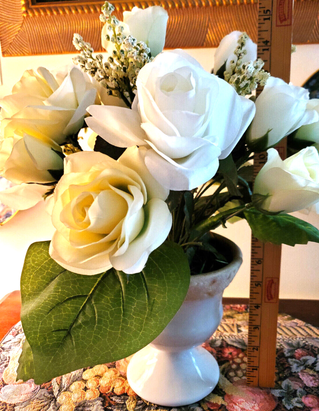 White and pale-yellow silk roses arrangement centerpiece in white vase