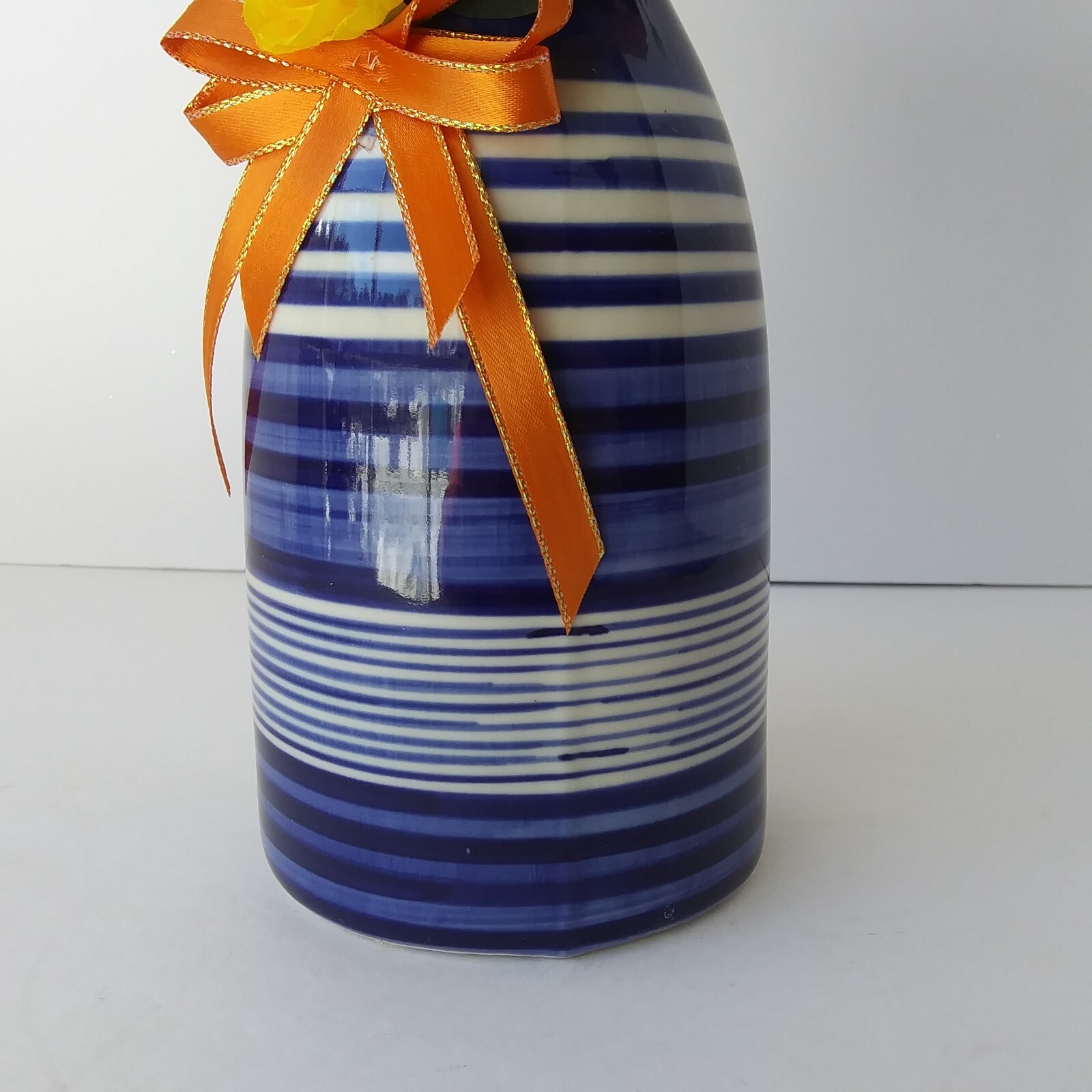 Blue White Striped Pottery Vase with Peach and Yellow Rose Floral Arrangement