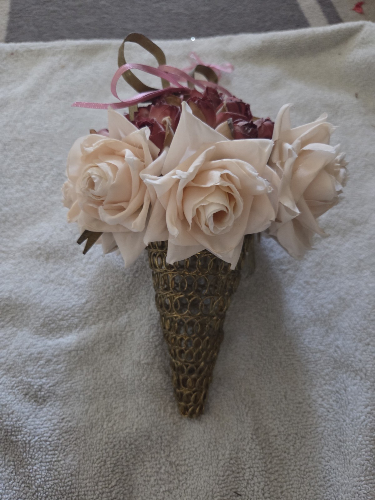 decorative artificial flower arrangement featuring cream and maroon roses