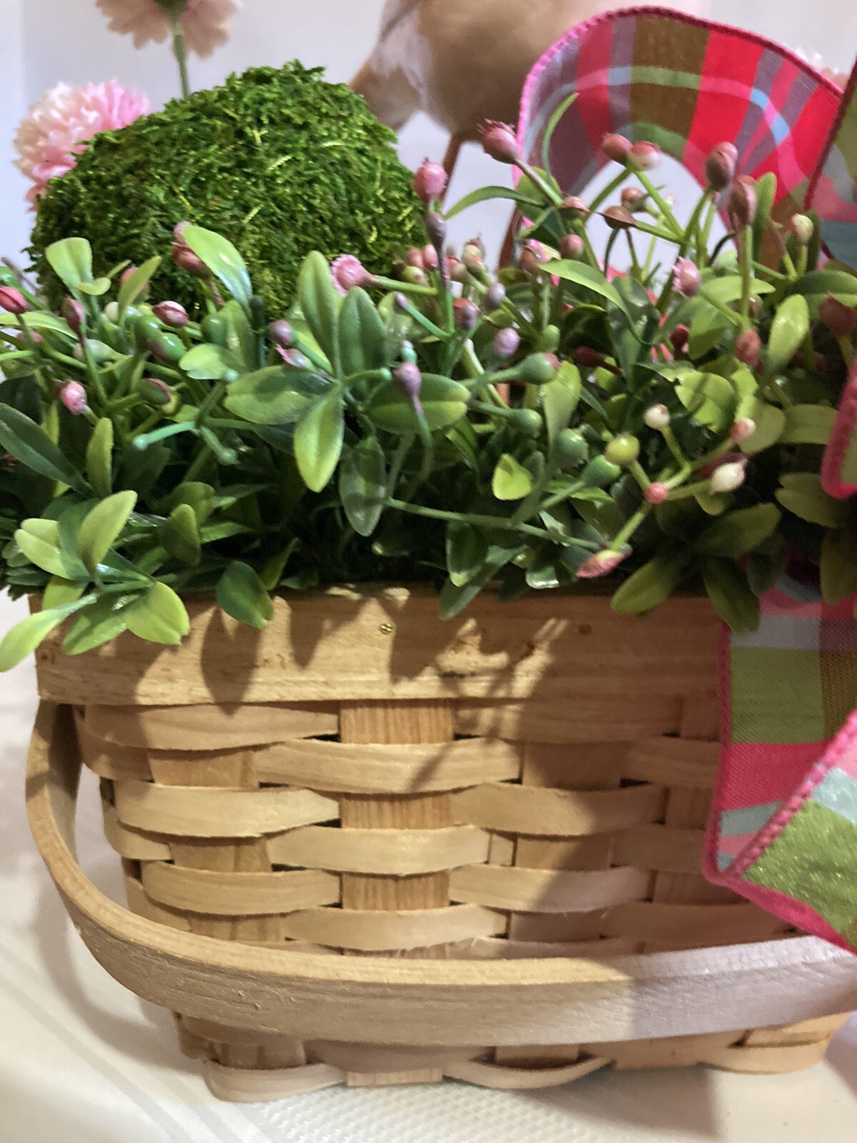 Delightful Pink Bird Surrounded In Boxwood Greenery In A Basket