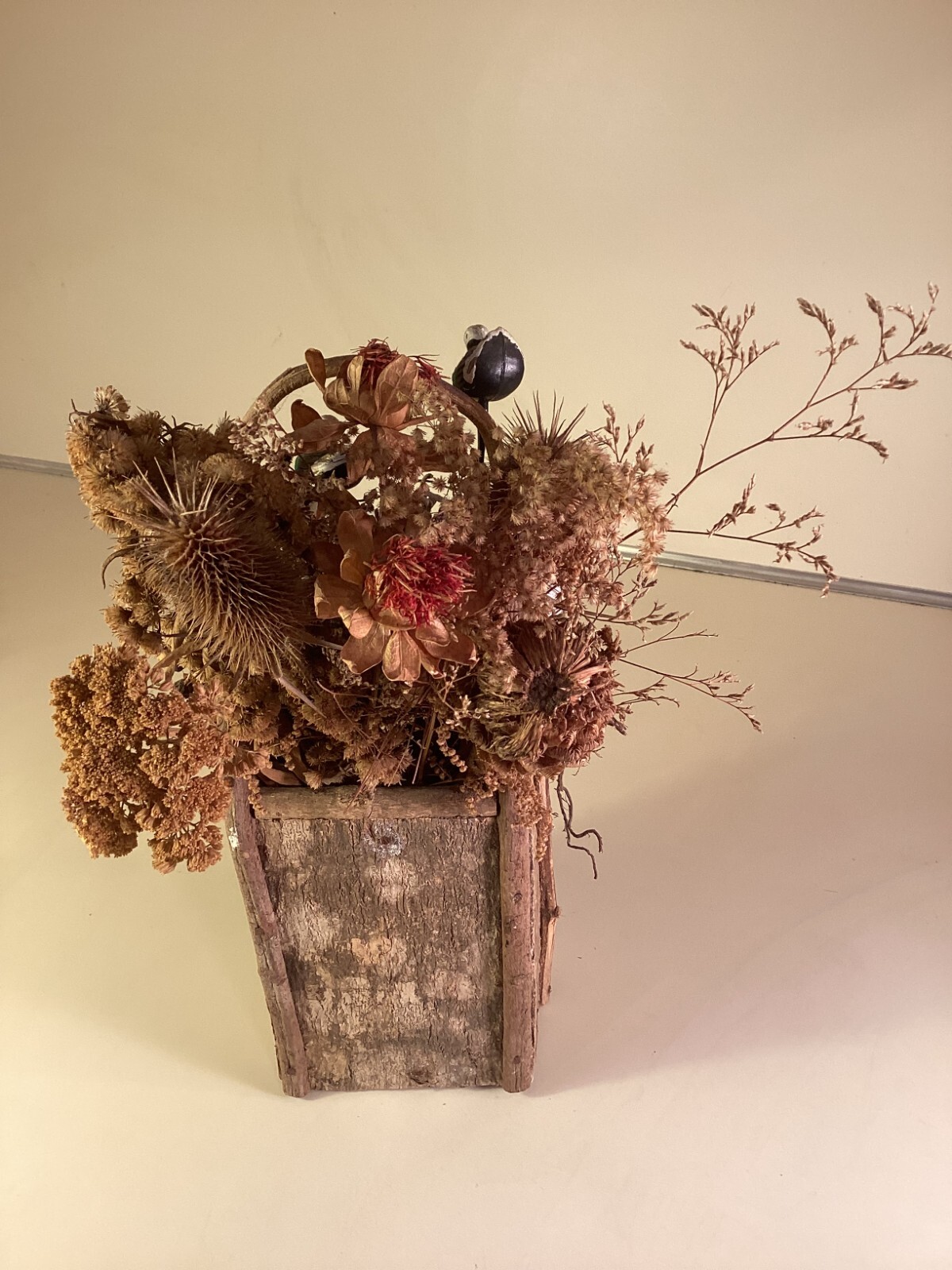 Wood birdhouse centerpiece with dried flowers, turkeys, twigs, windows, chimney