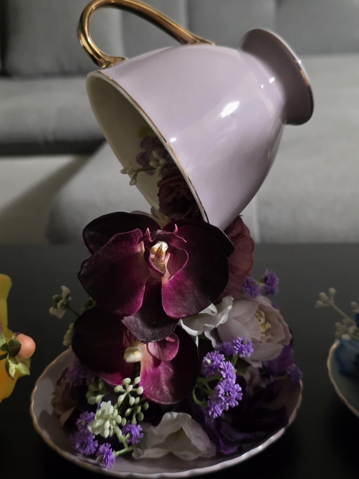 Floating Tea Cup Decorated With Faux Flowers Arrangement
