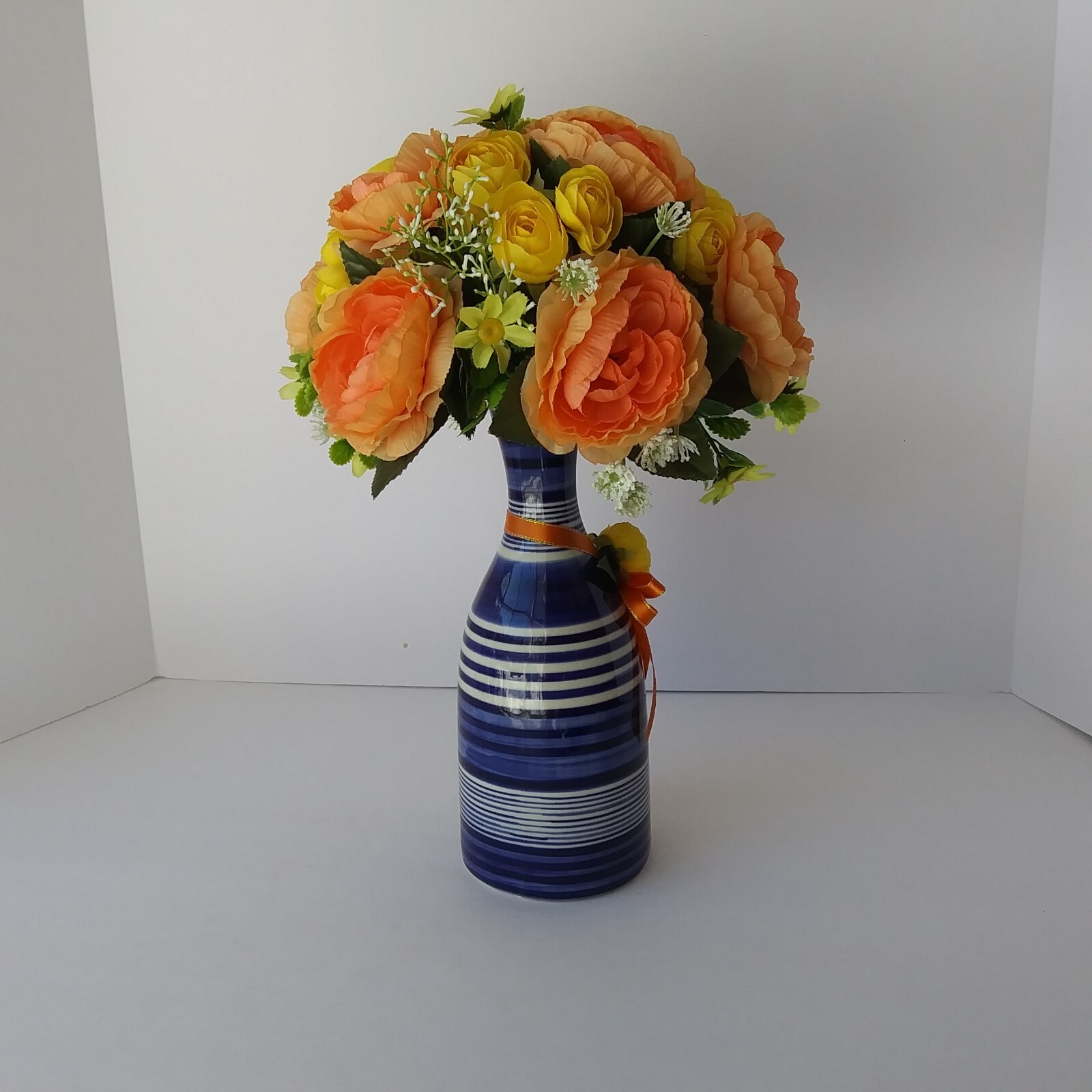 Blue White Striped Pottery Vase with Peach and Yellow Rose Floral Arrangement