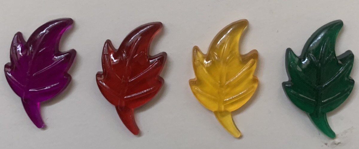 Bag of plastic leaves to scatter for Autumn decoration. Green,red,gold & violet 