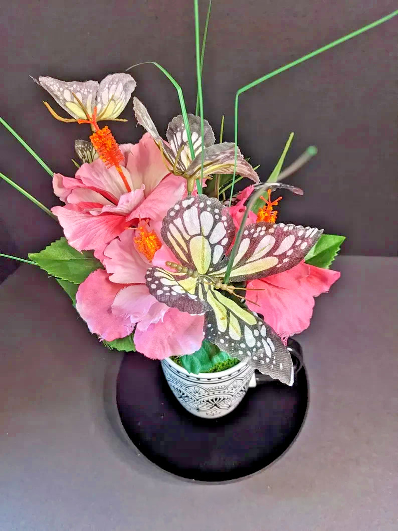 Butterfly‑Accented Pink Floral Arrangement in Decorative Patterned Mug