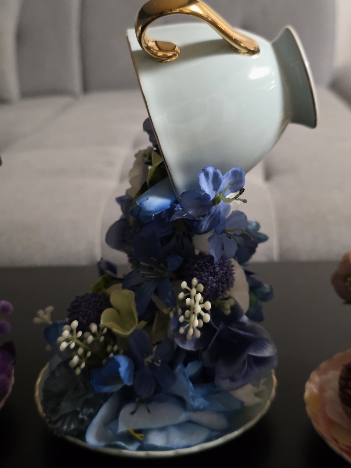 Floating Tea Cup Decorated With Faux Flowers Arrangement
