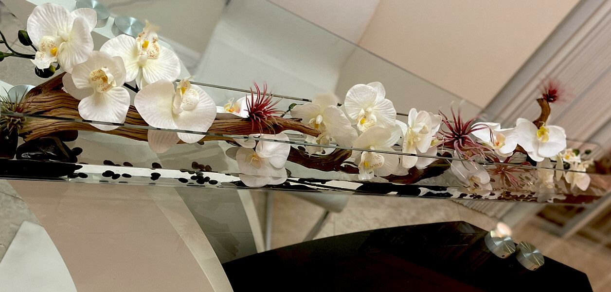 Silk orchid floral arrangement in rectangular glass vaseorchids arrangements48”