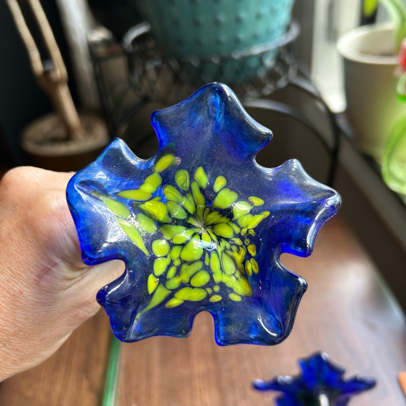 Handcrafted blue and yellow glass flower sculptures long green stems