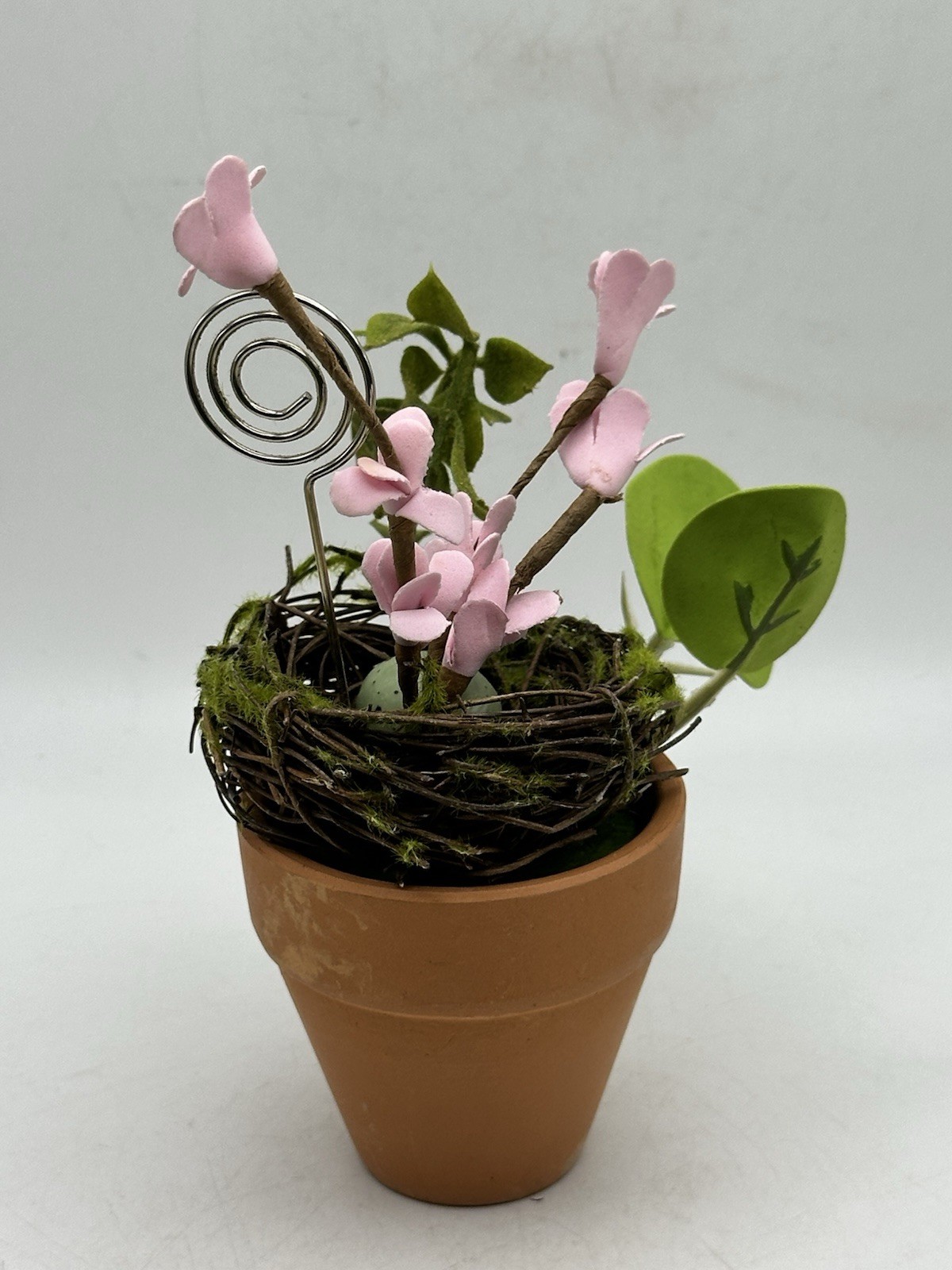 Photo Holder In Spring Themed Pot With Birds Nest Egg Flowers And Foliage