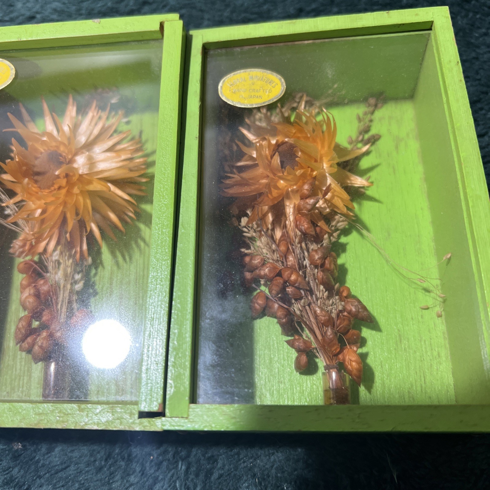 Two Modern Decorative Boxes Containing Dried Orange Flowers and Seed Pods. New