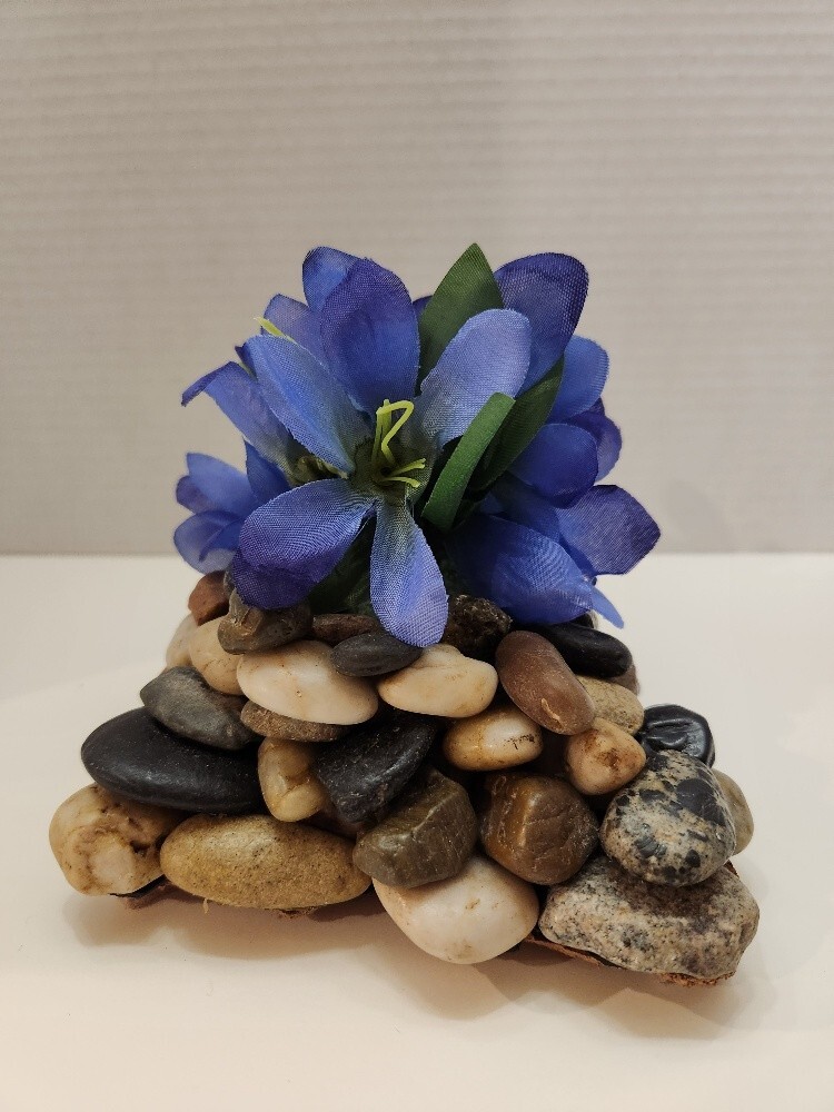 Touch of Spring, Lovely Blue Silk Flowers on a Bed of Polished Stones