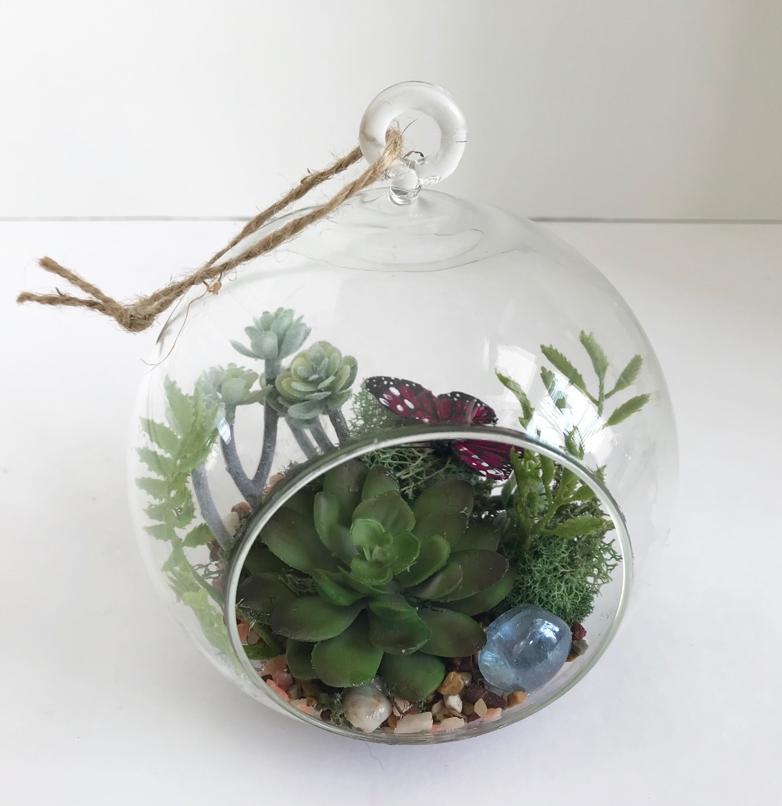Hanging Round Glass Vase with Artificial Green Grass Succulents and a Purple But