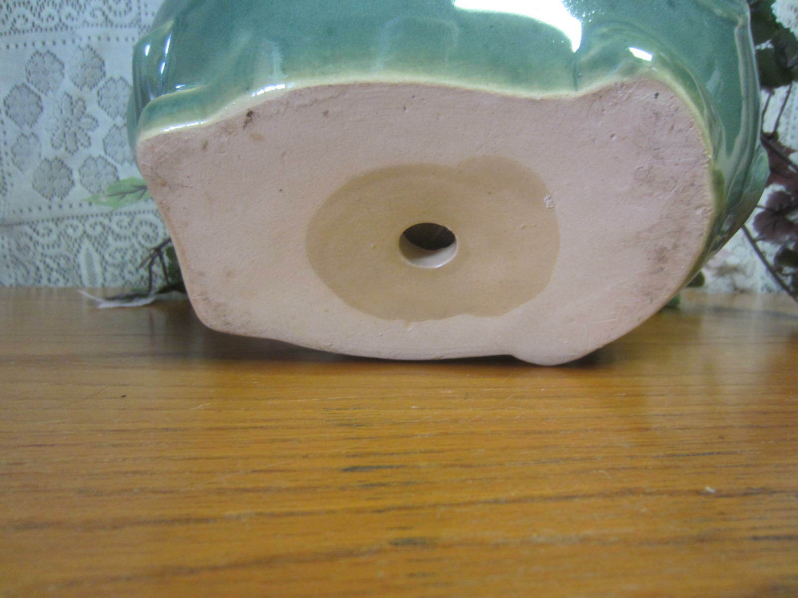 Green Elephant Planter With Green Foliage and Small Orange Flowers