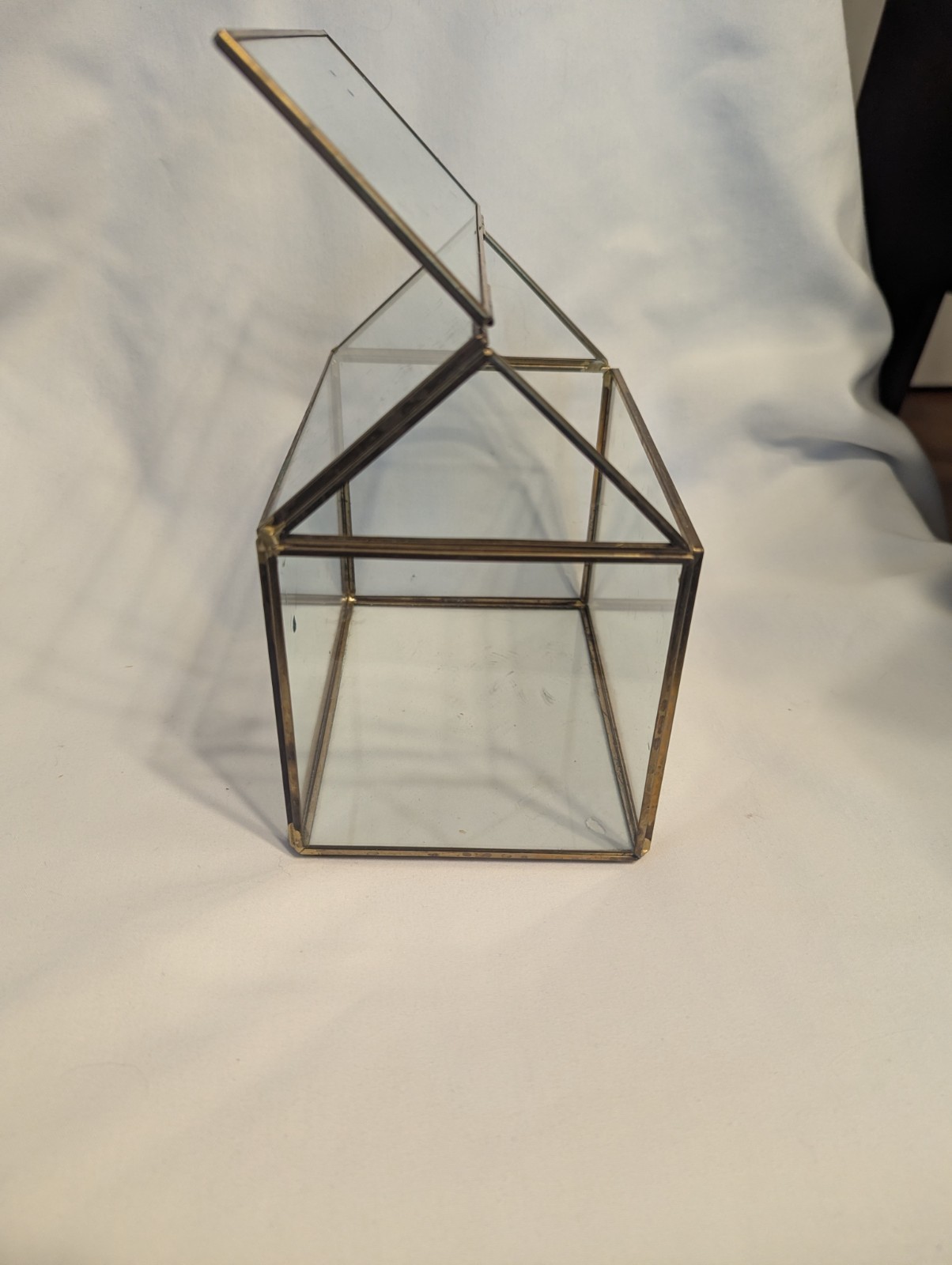 Small house shaped metal and glass terrarium