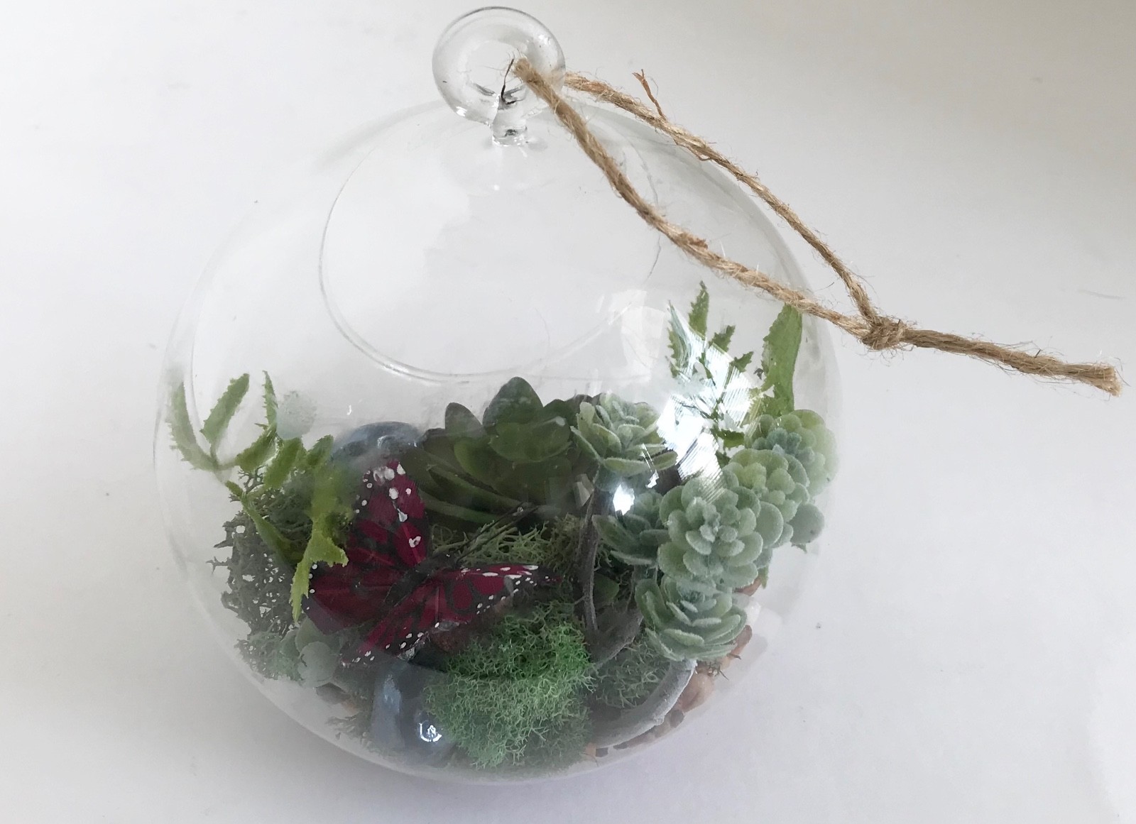 Hanging Round Glass Vase with Artificial Green Grass Succulents and a Purple But
