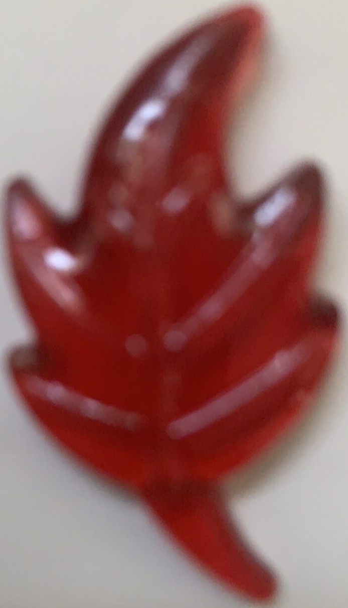 Bag of plastic leaves to scatter for Autumn decoration. Green,red,gold & violet 