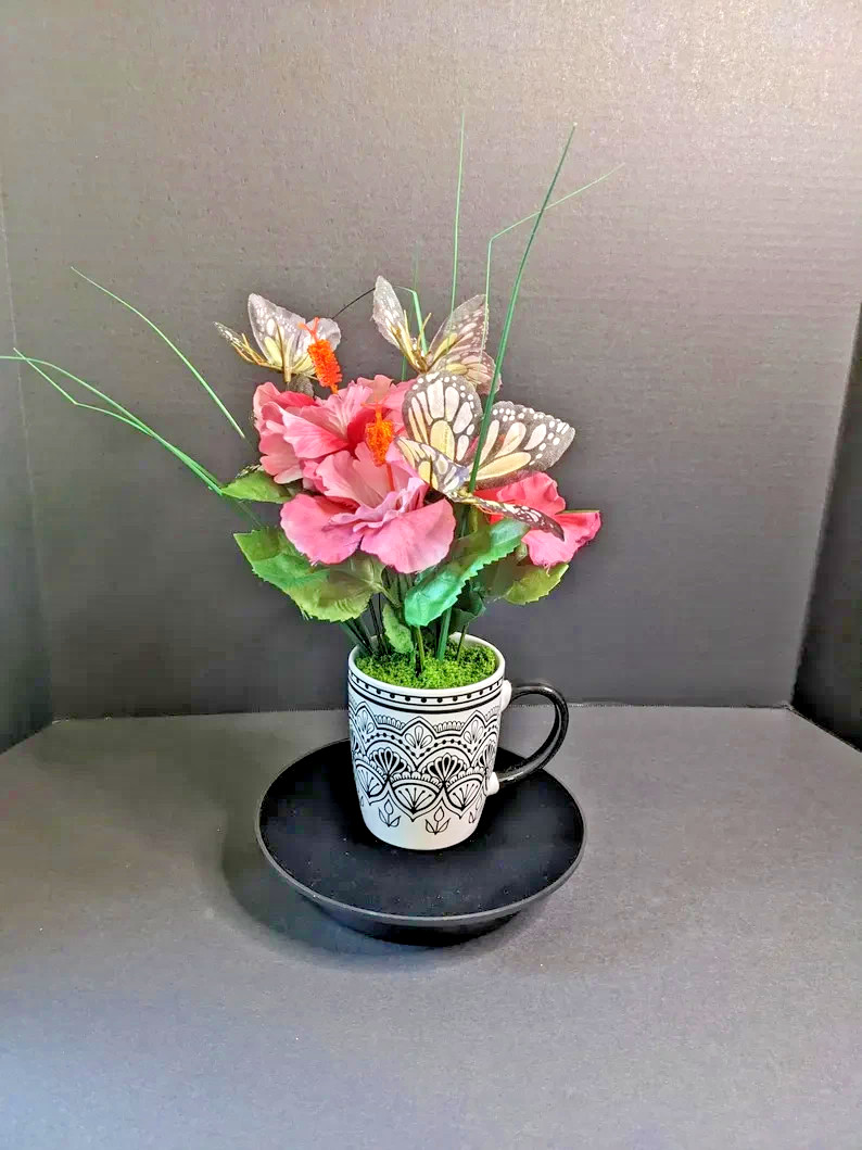 Butterfly‑Accented Pink Floral Arrangement in Decorative Patterned Mug