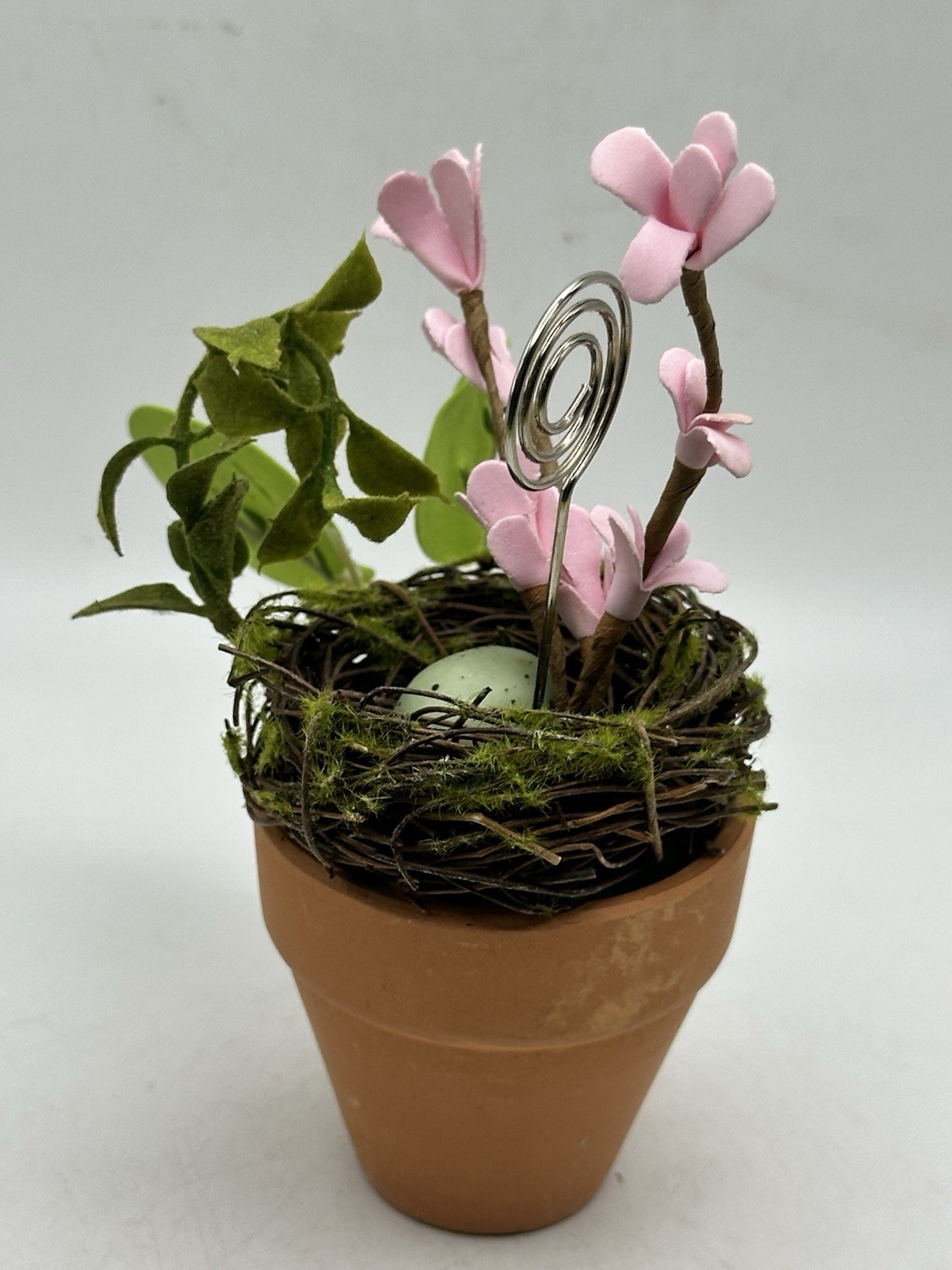 Photo Holder In Spring Themed Pot With Birds Nest Egg Flowers And Foliage