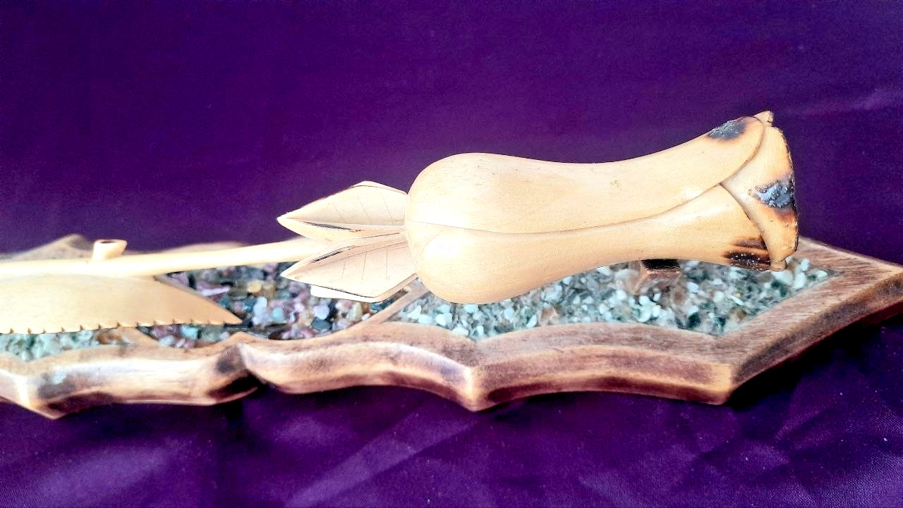 natural wood rose on a stand with hand-carved stones.