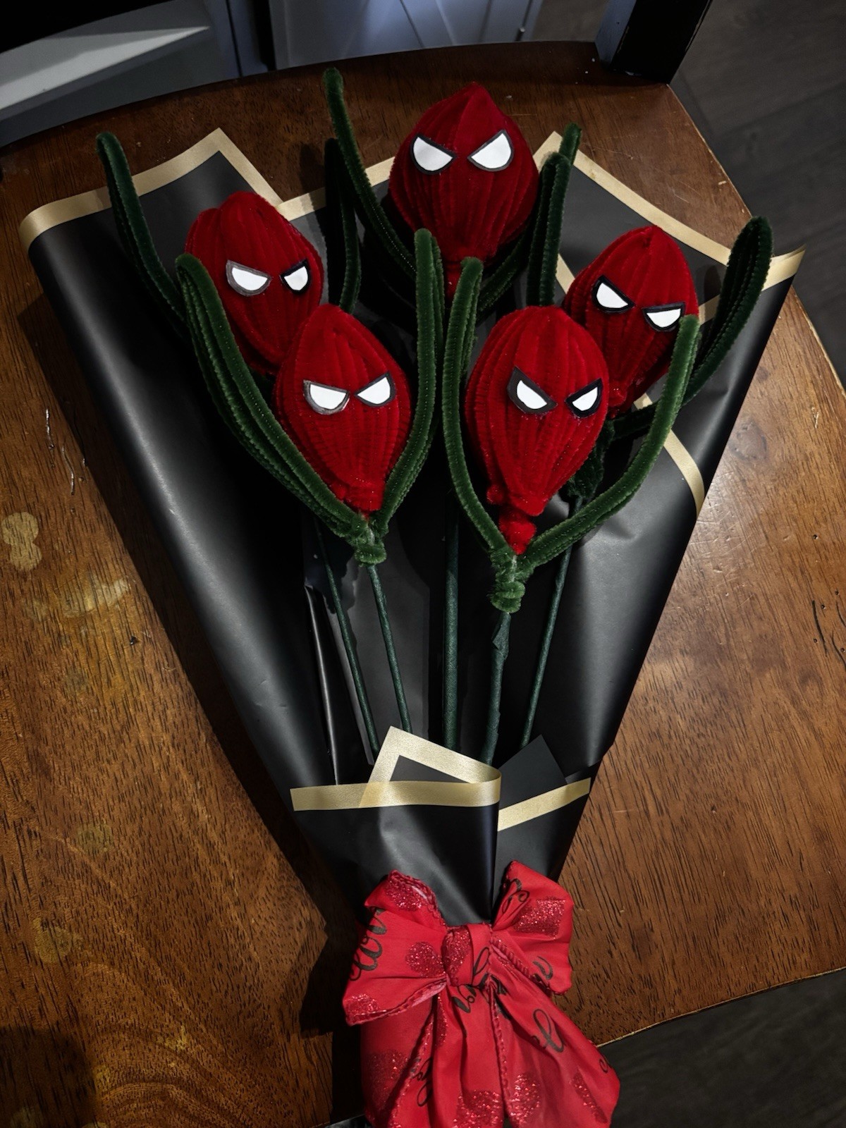 Artificial Spider-Man Themed Red Flower Bouquet with Black Wrap and Red Bow