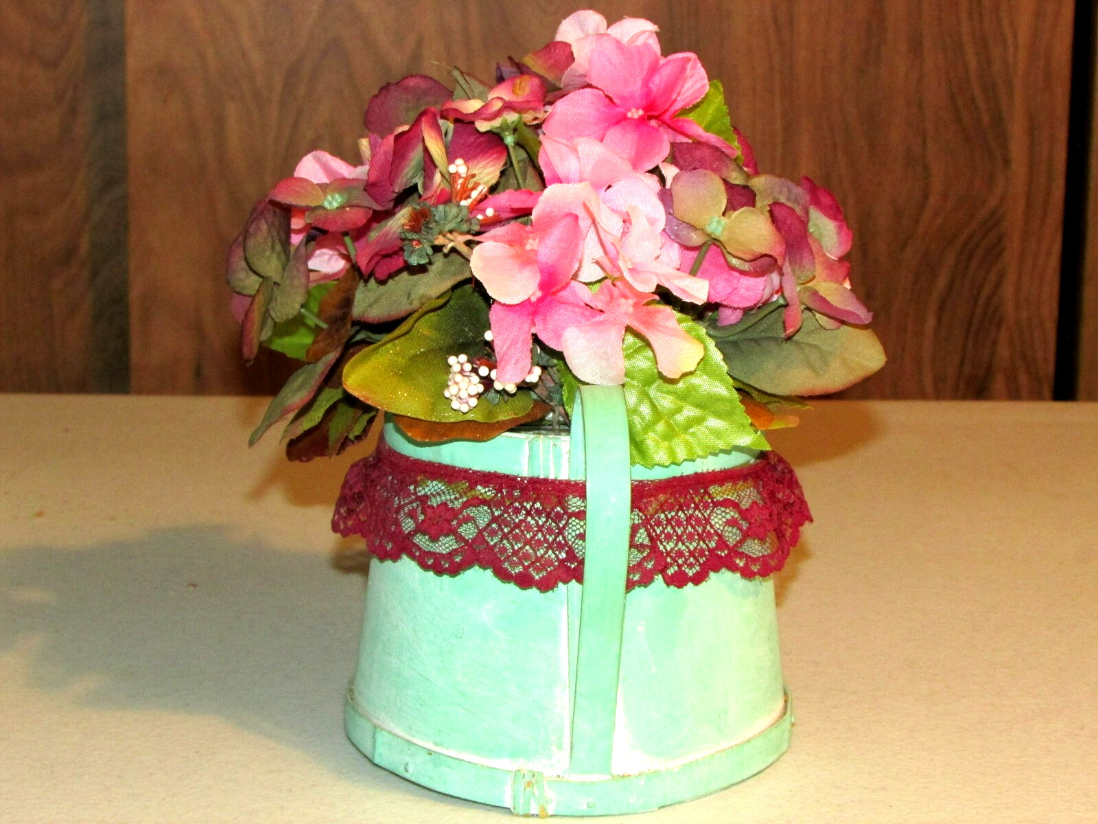 green cardboard WATER PAIL w/artificial FLOWERS 9x6x10″ overall (bdrm)