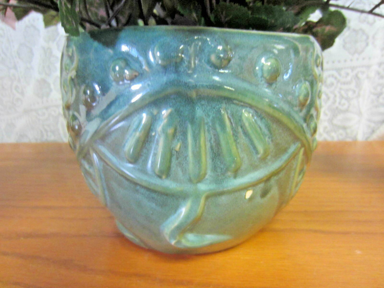 Green Elephant Planter With Green Foliage and Small Orange Flowers