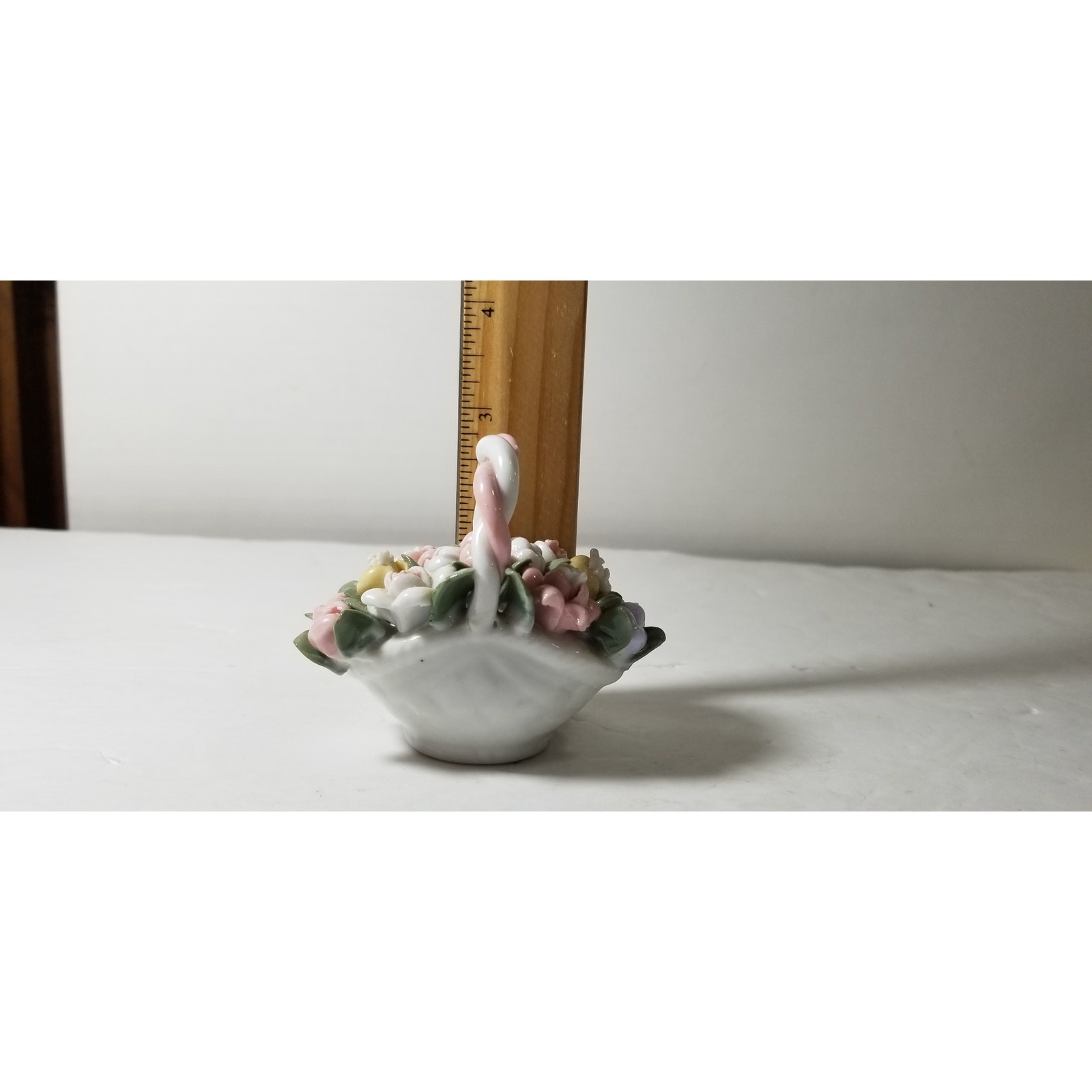 Three inch by 3 inch hand painted porcelain basket (1.1282)