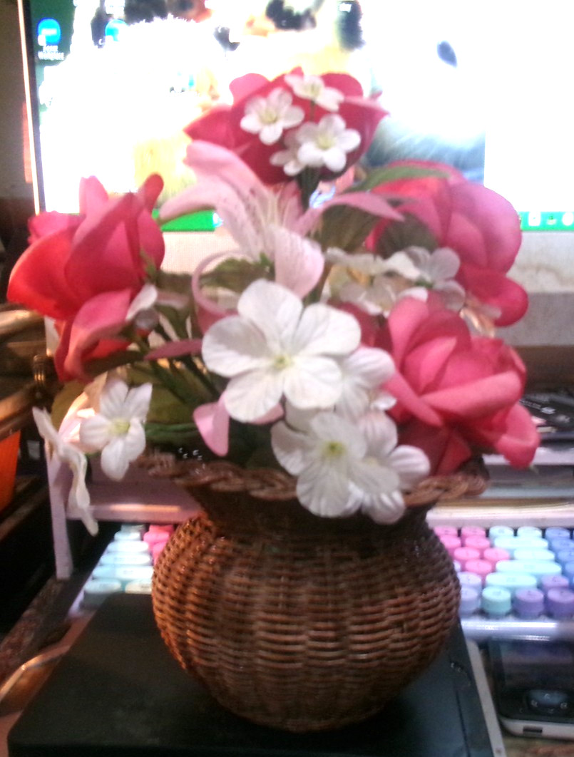 woven basket of artificial flowers hot pink and white