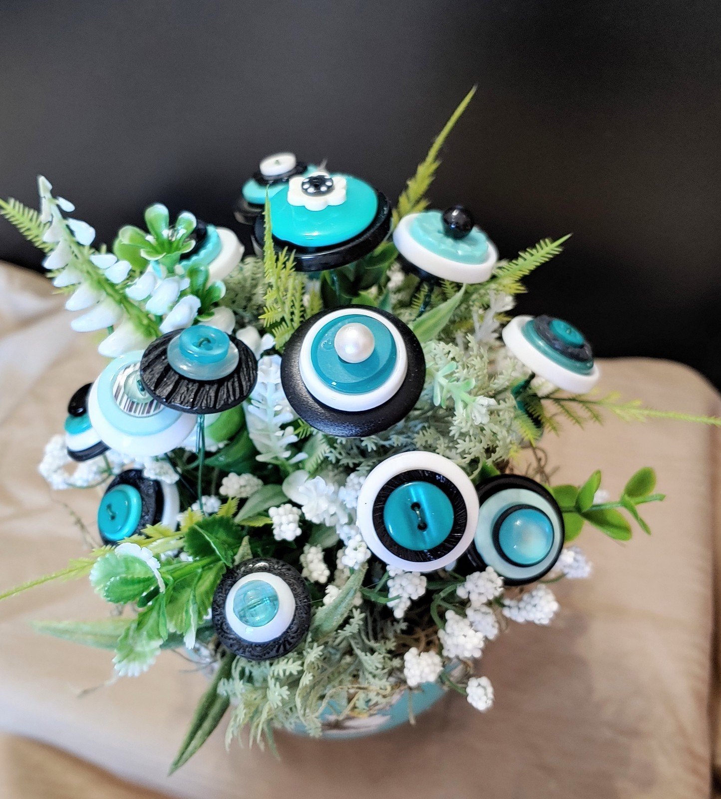 BUTTON BOUQUET IN matching turquoise, black, and white floral mug.