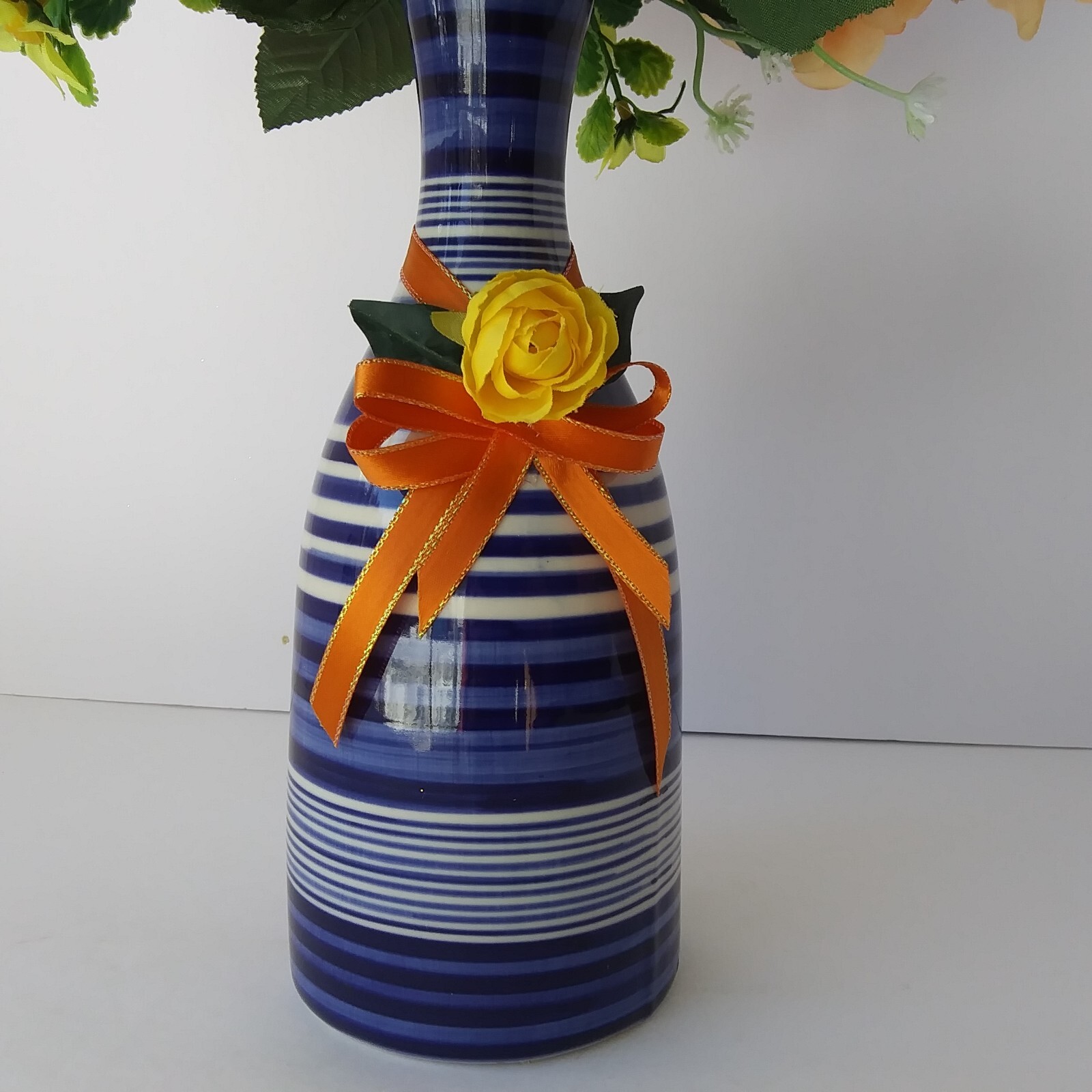 Blue White Striped Pottery Vase with Peach and Yellow Rose Floral Arrangement