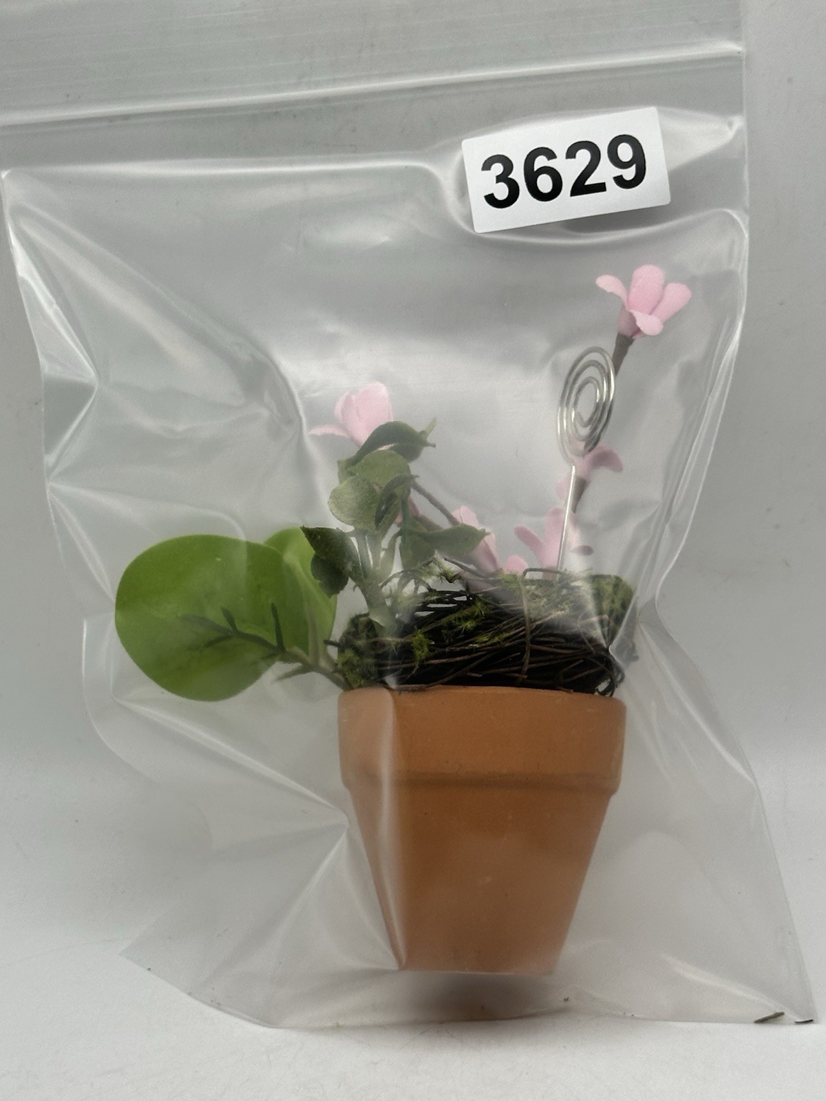 Photo Holder In Spring Themed Pot With Birds Nest Egg Flowers And Foliage