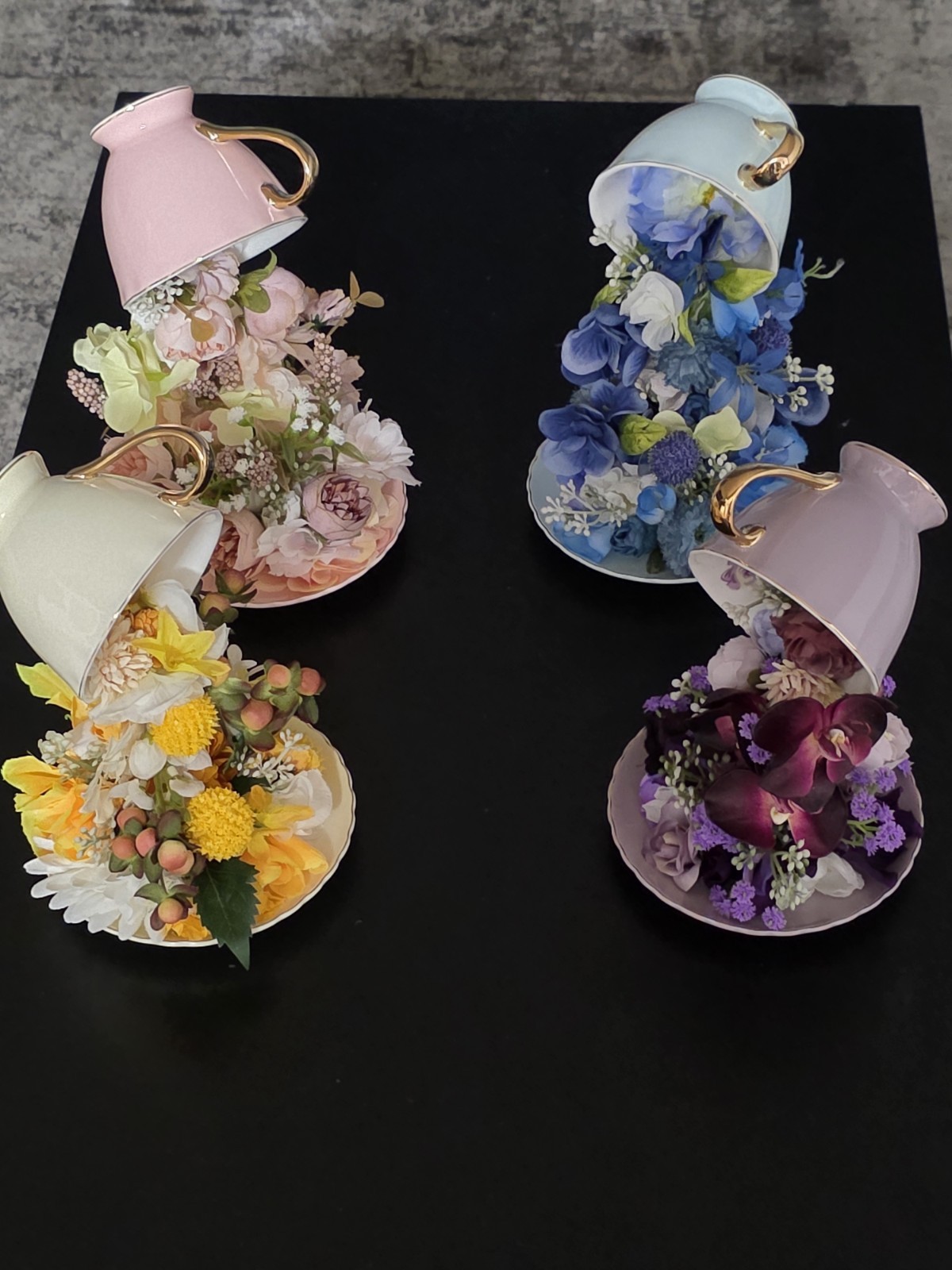 Floating Tea Cup Decorated With Faux Flowers Arrangement